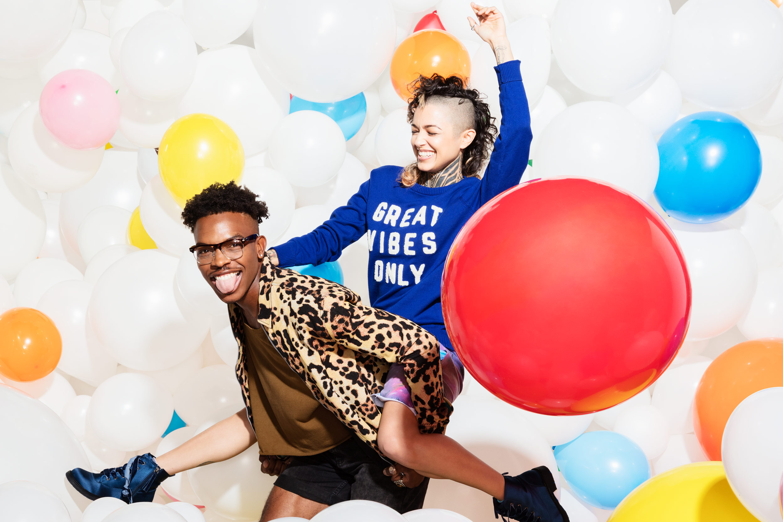 Guy gives a piggyback ride surrounded by balloons - Kim Genevieve Los Angeles Lifestyle Photographer