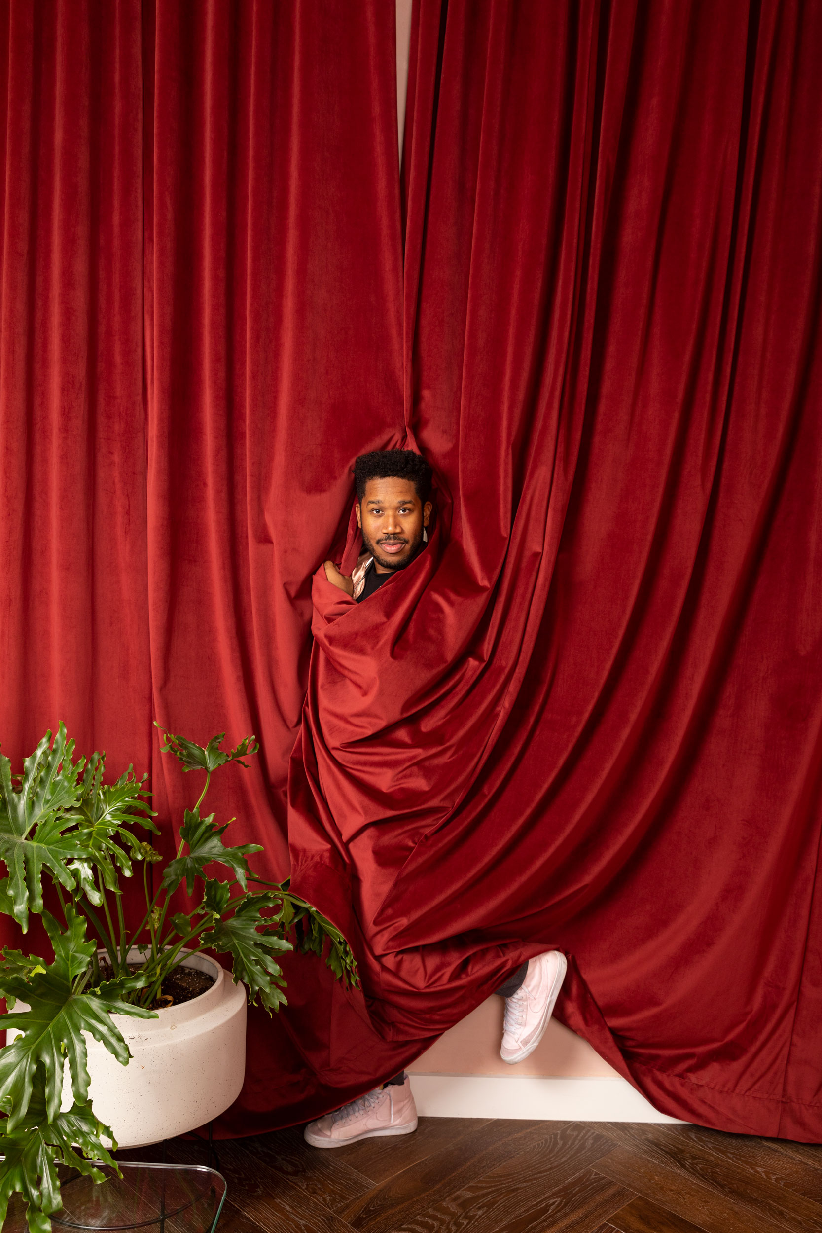 Millennial influencer wrapped in a red curtain. Kim Genevieve Los Angeles Portrait Photographer