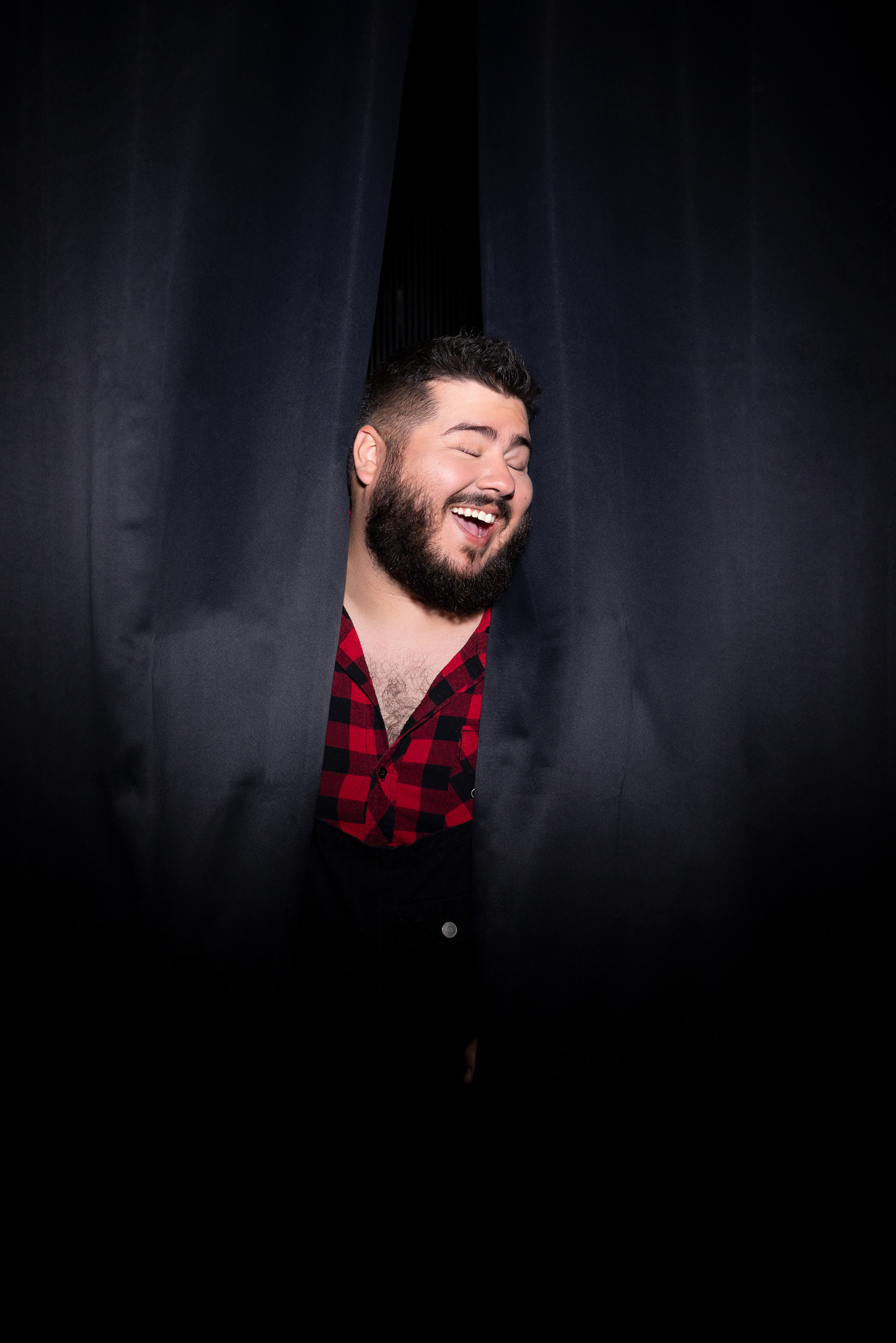 LGBTQ youth poking his head out from behind a curtain - Kim Genevieve Los Angeles Lifestyle Photographer