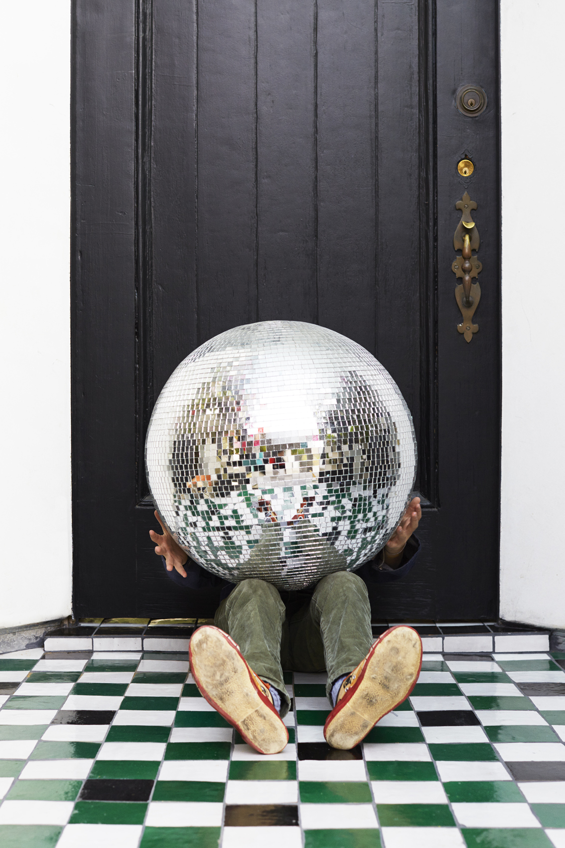Kid hiding behind a large disco ball - Kim Genevieve Los Angeles Lifestyle Photographer